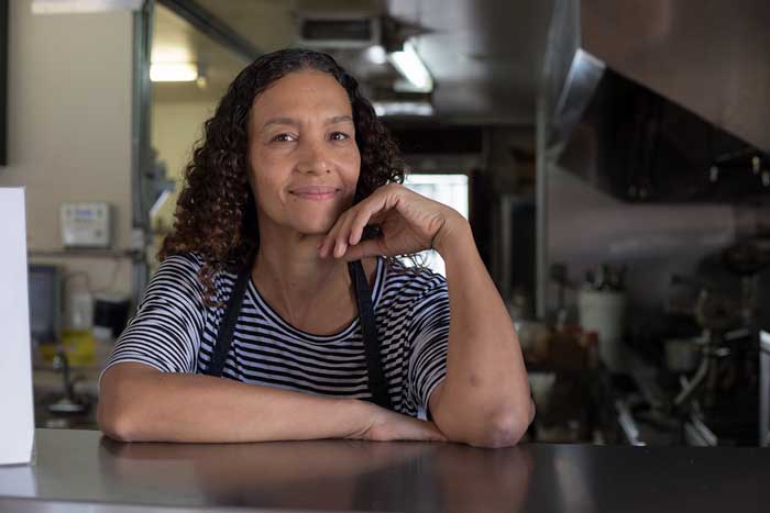 Angela Means poses for a picture inside her cook room.